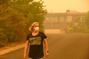 person-wearing-a-protective-mask-in-a-haze-of-wildfire-smoke