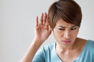person-with-hand-to-ear-listening-to-strange-sounds