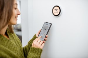 person-with-smart-thermostat